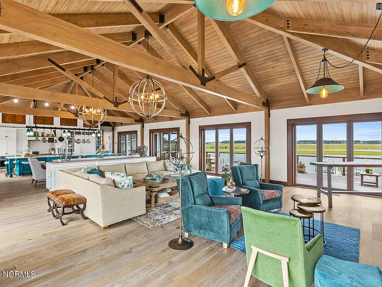 Wilmington Beach Mansion with Panoramic Views, renovated turquoise and natural wood living room with vaulted ceilings and exposed wood