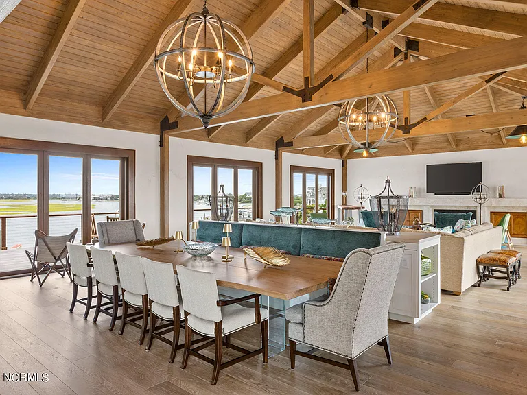 Wilmington Beach Mansion with Panoramic Views, renovated turquoise and natural wood living room and dining space with vaulted ceilings and exposed wood