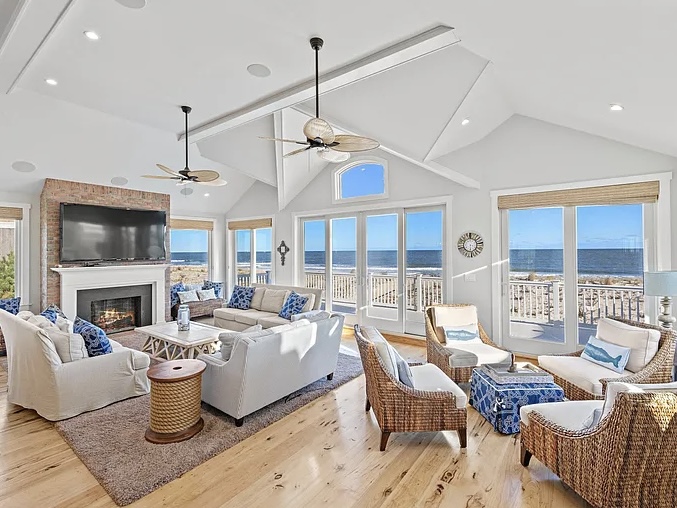 Renovated LBI Beach Mansion, interior of 6601 Ocean Blvd, Long Beach Township, NJ showing direct Atlantic Ocean views from the vaulted ceiling living room