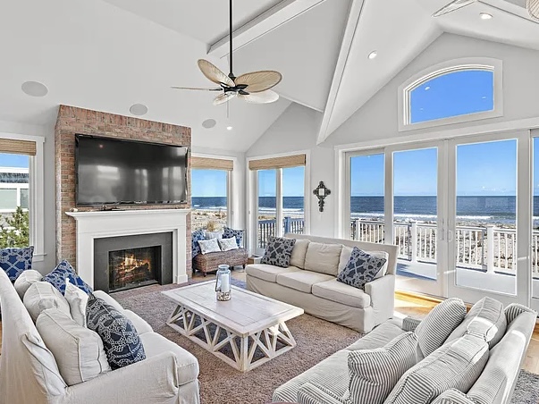 Renovated LBI Beach Mansion, interior of 6601 Ocean Blvd, Long Beach Township, NJ showing direct Atlantic Ocean views from the vaulted ceiling living room