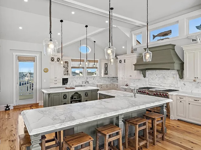 Renovated LBI Beach Mansion, interior of 6601 Ocean Blvd, Long Beach Township, NJ showing direct Atlantic Ocean views from the open concept green and white kitchen