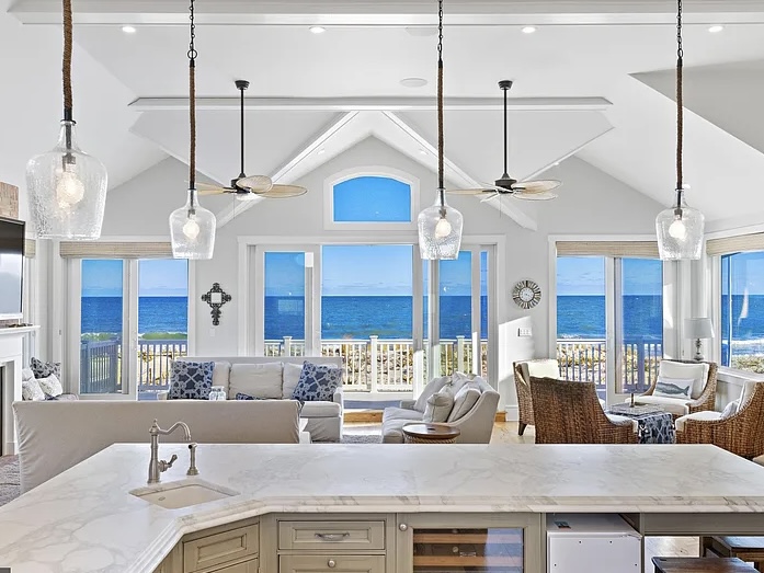 Renovated LBI Beach Mansion, interior of 6601 Ocean Blvd, Long Beach Township, NJ showing direct Atlantic Ocean views from the open concept green and white kitchen