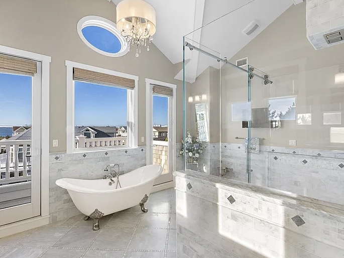 Renovated LBI Beach Mansion, interior of 6601 Ocean Blvd, interior master bathroom with white marble and atlantic ocean beach views