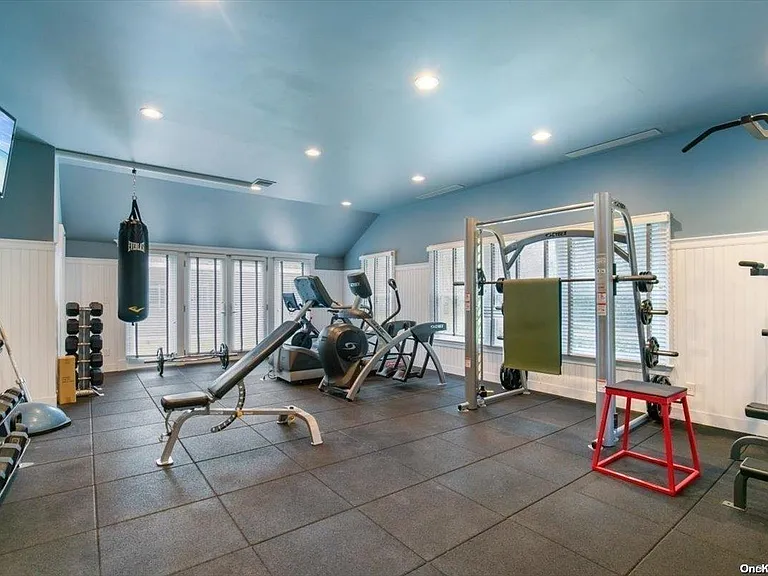 Locust Valley New York mansion, modern home gym with high ceilings and workout equipment